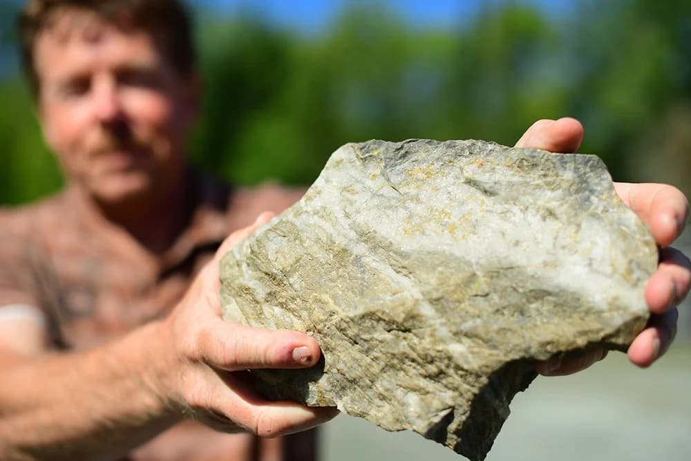 Geologist holding mineralized rock sample from Cameron Project